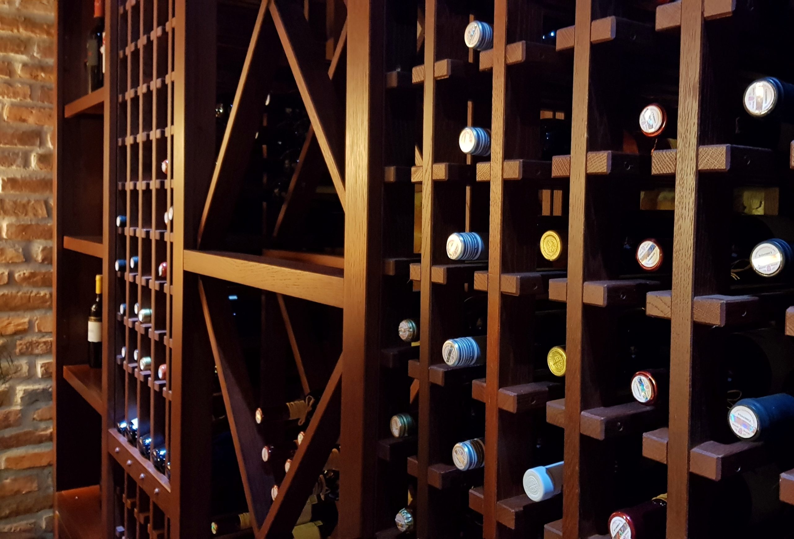 Wine cellar bottles in a wooden rack &mdash; the kind of collection valuables insurance protects